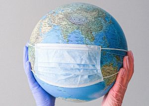 A globe with a medical mask.