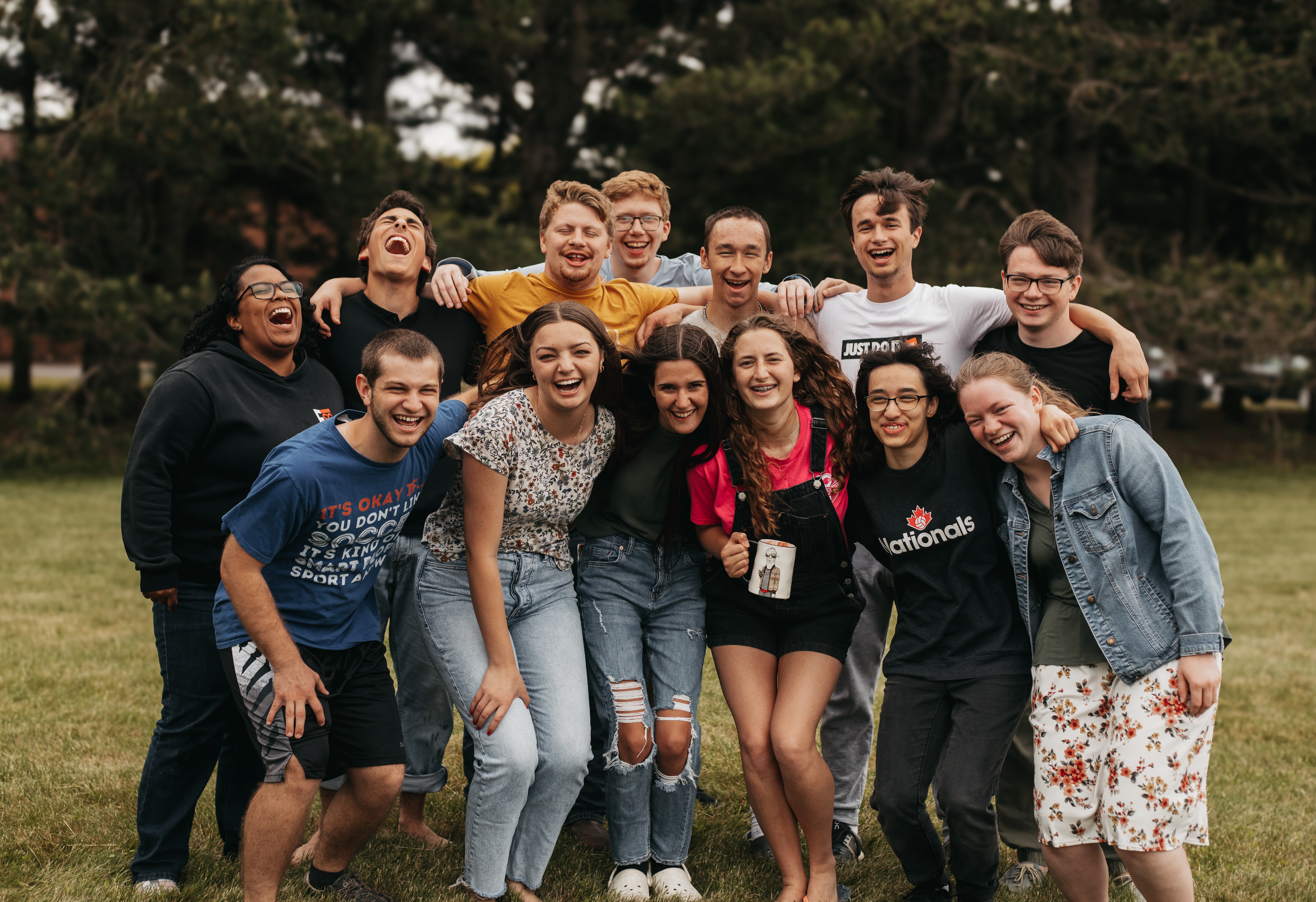 A group of students laugh while posing for a photo