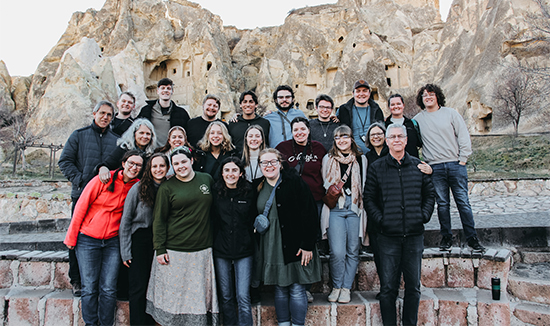 A group of students standing in front of rock monuments.