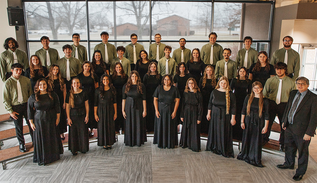 The RBC Chorale pose on risers in the student center