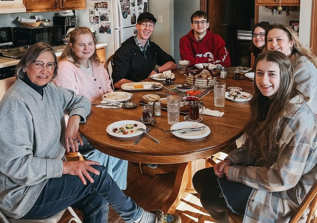 A small group of students meet around a table for a discipleship group with an RBC staff member