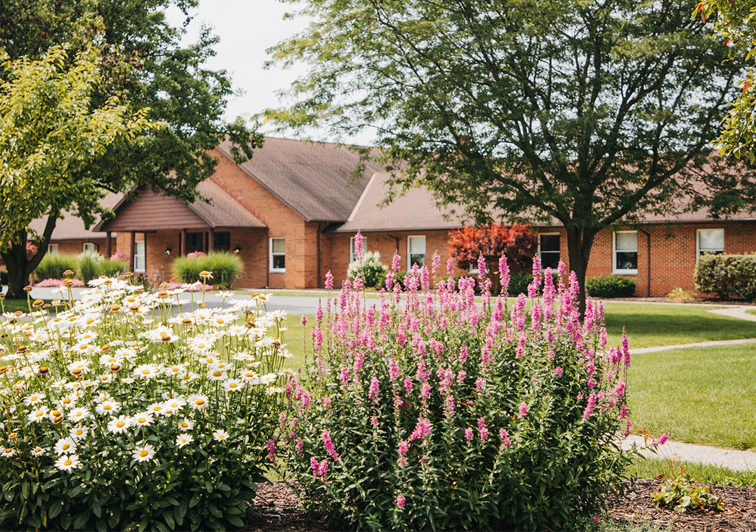 Spring flowers with the Rosedale Bible College chapel and administration building in the background