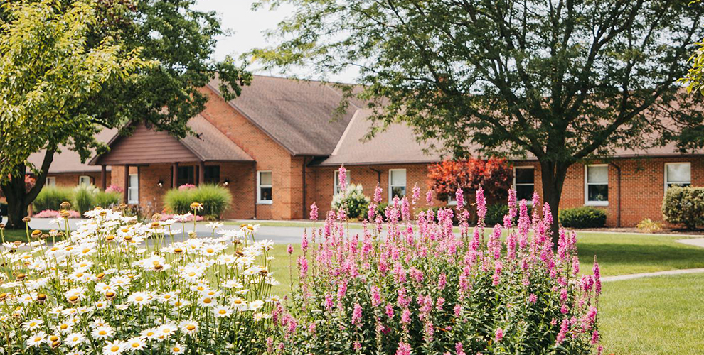 Spring flowers with the Rosedale Bible College chapel and administration building in the background