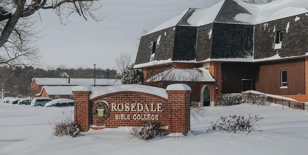 Snow covering the Rosedale Bible College sign and classroom building